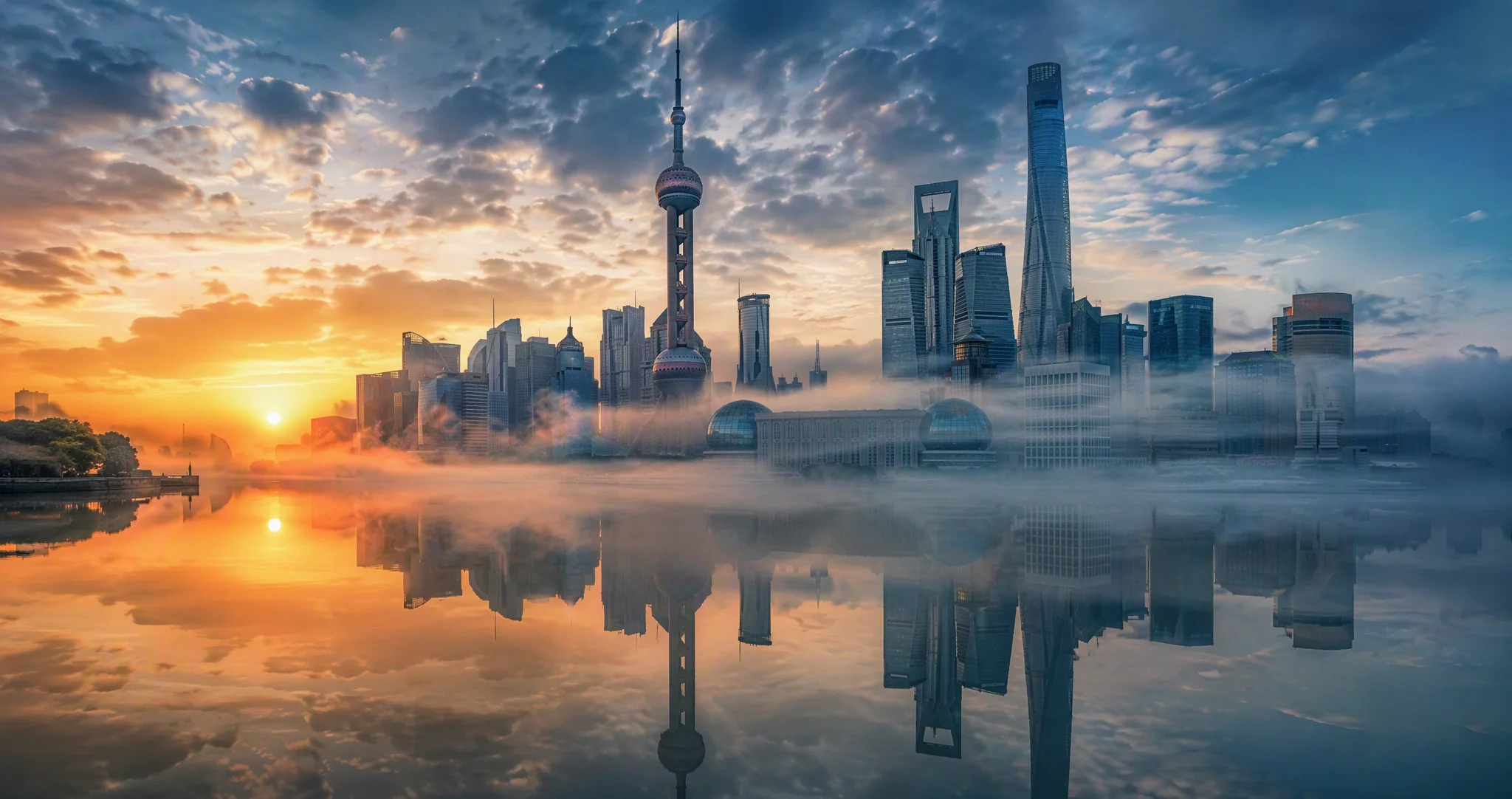 Shanghai skyline glowing in golden dawn light over the Huangpu river